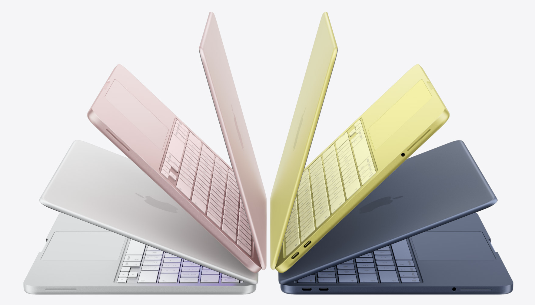 MacBook Neo held in a hand showing the display